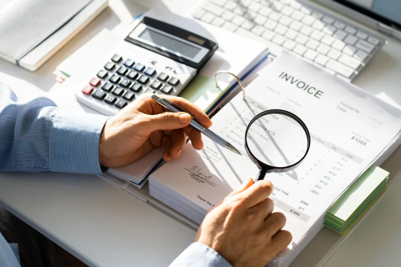 Corporate investigator examining financial documents