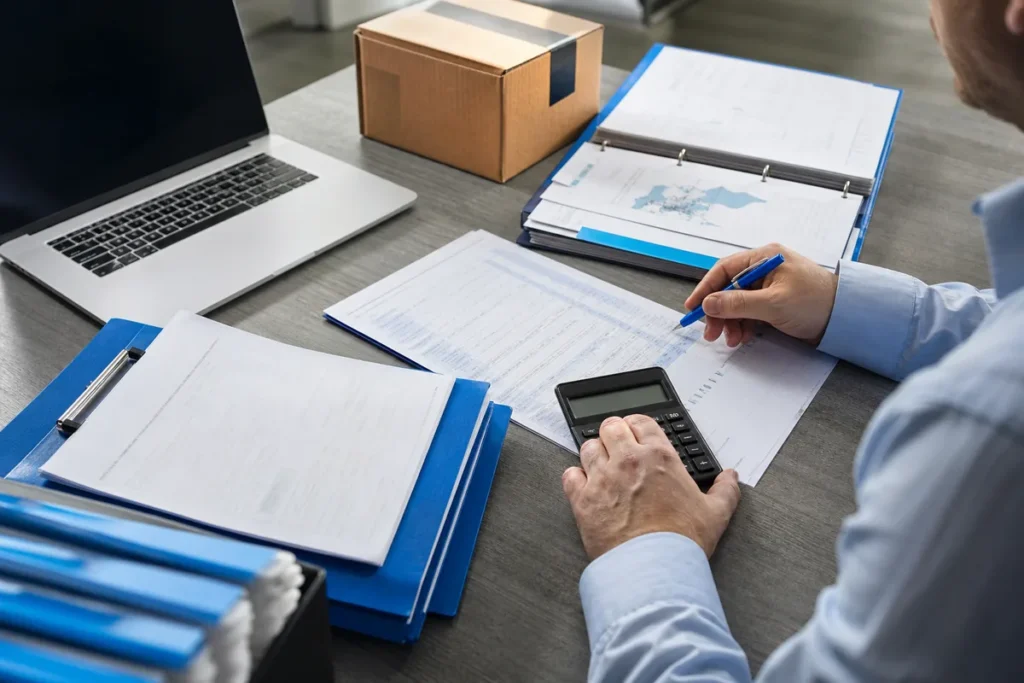 Investigator checking supplier records during a fraud investigation